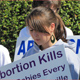 Mission Youth members hold signs in silent witness