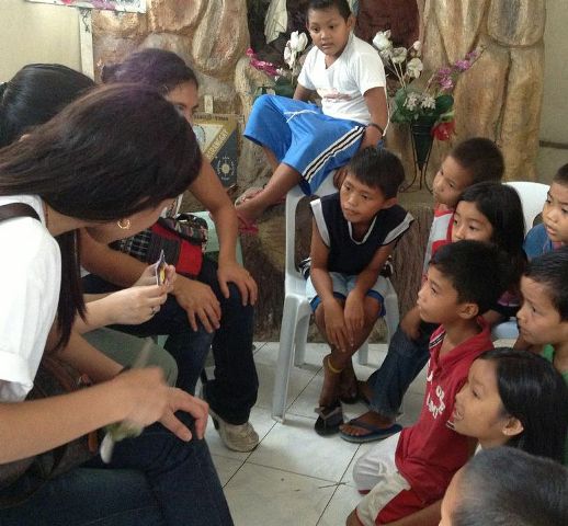 Explaing a holy card to the children