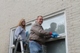 Christina Van Dorpe paints windows with her dad in Oxford