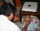 Fr Dominic Pham, LC, gives a gesture of tenderness to a little girl sick with meningitis in the Manilia slums. 