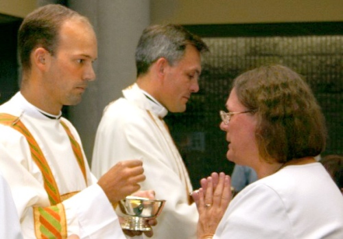 Fr. Daniel Brandenburg distributing communion