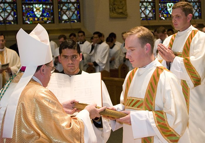 Fr. Michael receives the Book of the Gospels from Bishop Dennis Sullivan, auxiliary bishop of New York, during his ordination to the diaconate on June 14, 2009.
